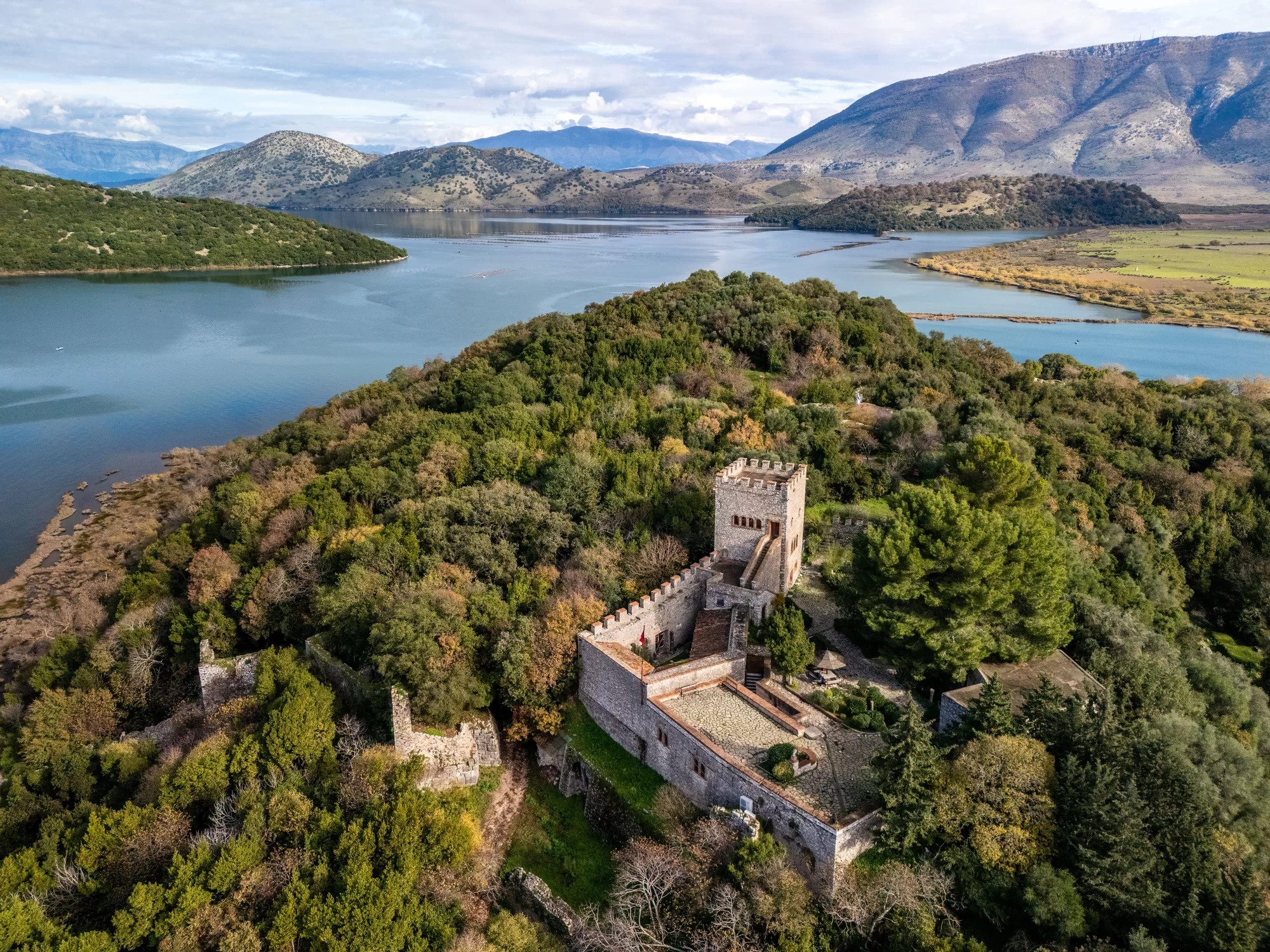 Aerial view of the medieval castle surrounded by lush greenery in Butrint National Park, Albania