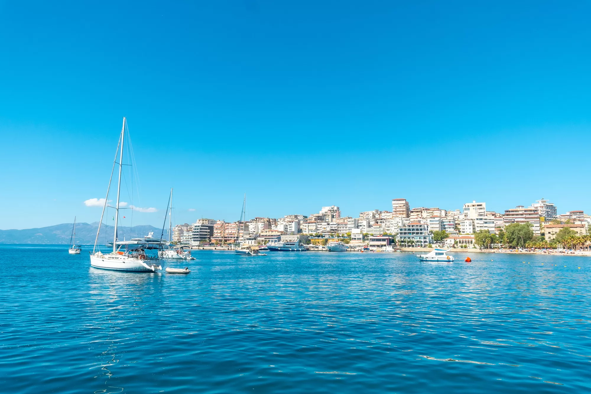 Tourist boats on the beaches of the city of Sarande or Saranda on the Albanian riviera seen